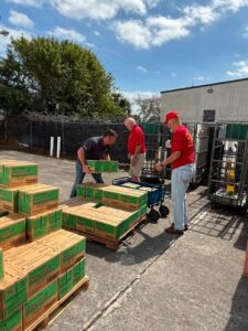 Volunteers unloading 2,000 cases of Girl Scout cookies at Forgotten Soldiers Outreach warehouse to ship to deployed service members