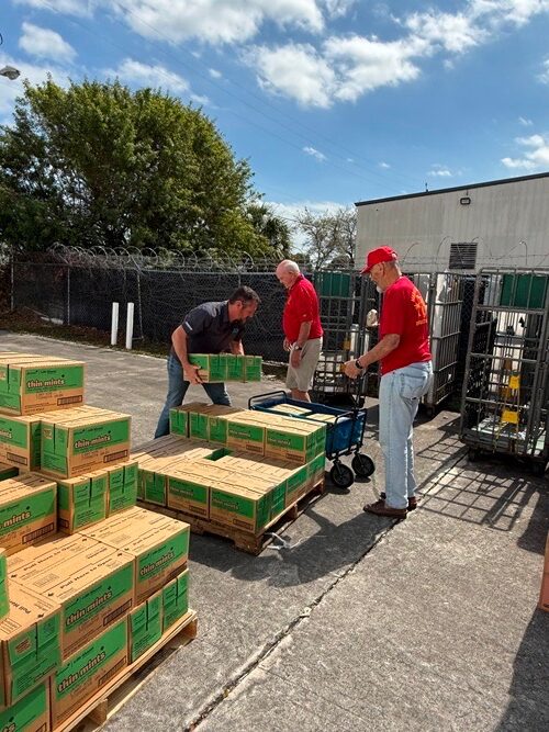 Volunteers unloading 2,000 cases of Girl Scout cookies at Forgotten Soldiers Outreach warehouse to ship to deployed service members
