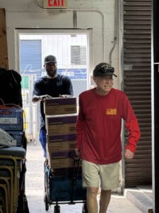 volunteers moving girl scout cookies into the warehouse in Lake Worth, FL.